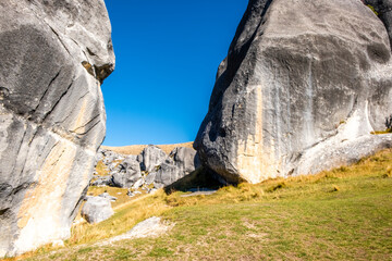 Rock formation in the middle of alpine grassland. South Island, New Zealand.