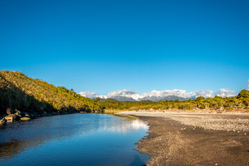 The empty beach of a quiet river. South Island, New Zealand.