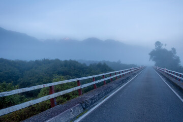 Bridge across the river on a misty morning. South Island, New Zealand.