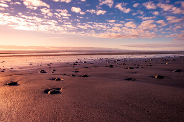 Sunset on a remote beach on the West Coast. South Island, New Zealand.