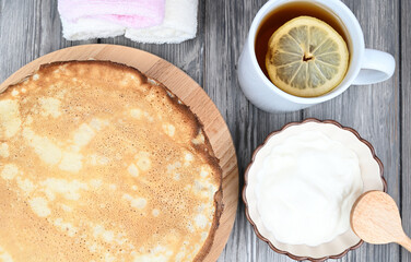 Top view of pancakes that are stacked on a wooden board.