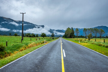 Fototapeta na wymiar A highway running through farmland. South Island, New Zealand.