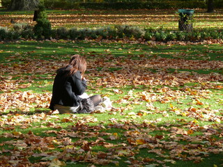Woman enjoying the autumn leaves