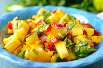 Plate with fresh mango salsa, closeup