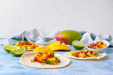Tortillas with fresh mango salsa on color background