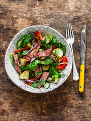 Potato, beef steak, romano and vegetable salad on a wooden background, top view. Balanced diets healthy food