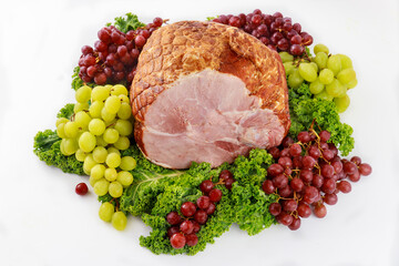 Whole pork ham with fresh fruits. Healthy food.