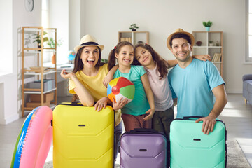 We've packed suitcases and are ready for holiday. Happy young parents and little kids having fun at...