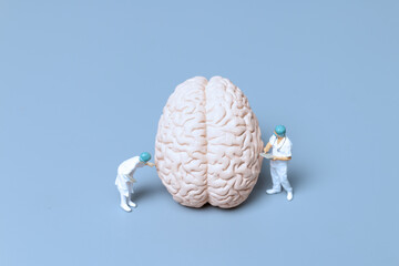 Miniature Doctor checking and analysis alzheimer's disease and dementia of brain, Science and...