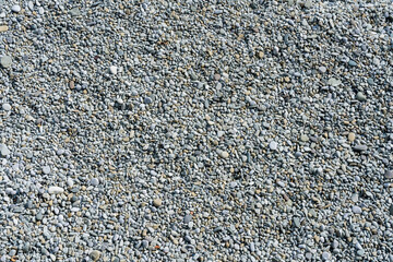 Round pebbles on the beach as a natural background
