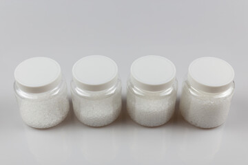 Transparent bottle inside with plastic beads. white polymer. white plastic beads.