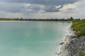 white sand and cyan colored water in artificial ash ponds of Nazarovo power station (Krasnoyarsk Krai, Russia)