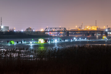 Fototapeta na wymiar frozen river, night and ice anglers