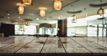 Empty wooden table top with lights bokeh on blur restaurant background.