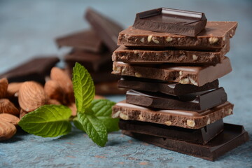 Chocolate tower. Stack of chocolate pieces. The chunks of broken chocolate. Background with chocolate.