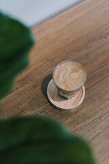 Top view of cup of dirty coffee - A glass of espresso shot mixed with fresh cold milk.