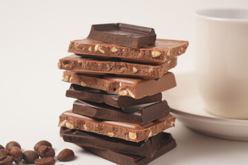 Chocolate tower. Stack of chocolate pieces. The chunks of broken chocolate. Background with chocolate.