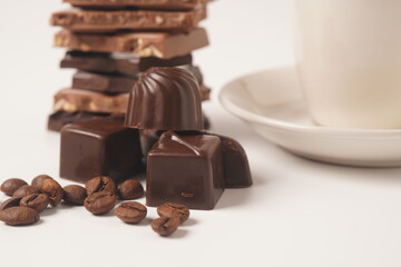 Chocolate tower. Stack of chocolate pieces. The chunks of broken chocolate. Background with chocolate.