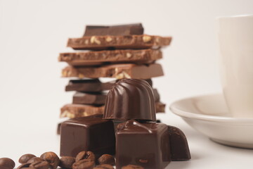 Chocolate tower. Stack of chocolate pieces. The chunks of broken chocolate. Background with chocolate.