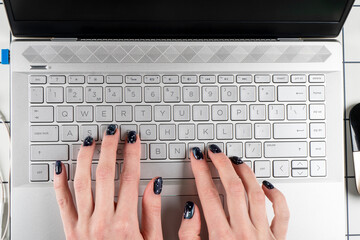 Top view female hand using computer keyboard. Hand typing on desktop office computer keyboard. Woman using laptop. Business lady typing on a computer or laptop keyboard. Business workplace