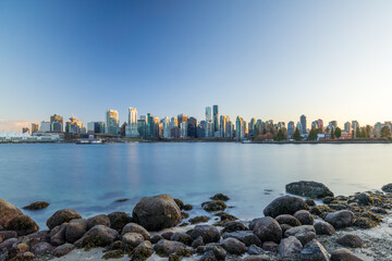 Vancouver downtown skyline panoramic view at sunset time. Skyscrapers reflection on the Vancouver Harbour. British Columbia, Canada.