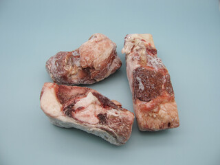 three pieces of frozen beef on the bone for broth