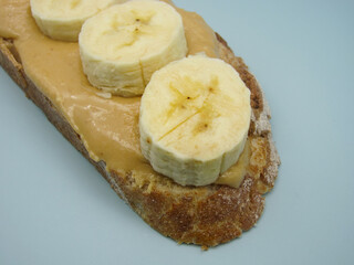 Sandwich: bread spread with peanut butter and banana slices
