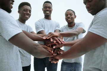 group of diverse guys making a tower out of hands