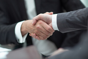 close up. business partners, confirming their agreement with a handshake.