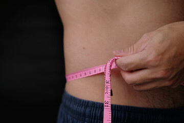 woman measuring her waist