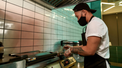 Chef in an apron preparing food in the kitchen