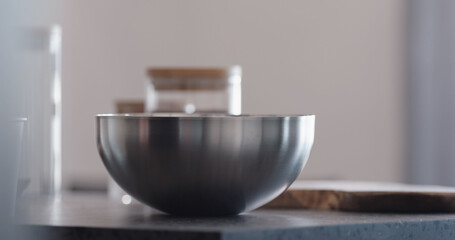 making granola in steel bowl on kitchen countertop