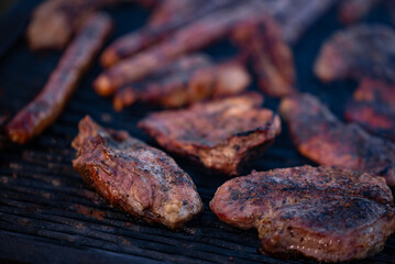 roasted chicken and pork steak with sausages. grilled meat cooked and smoked