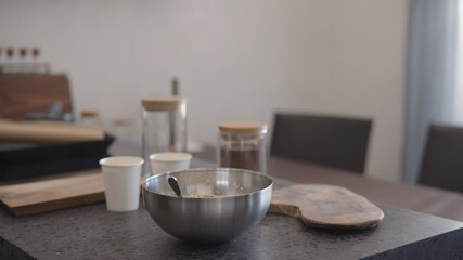 making granola in steel bowl on kitchen countertop