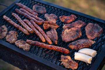 roasted chicken and pork steak with sausages. grilled meat cooked and smoked