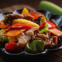 Delicious homemade stir-fried salted pork with colorful vegetablesbaby corn.