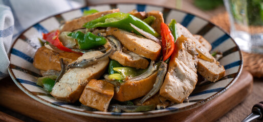 Homemade stir-fried dried beancurd with dried fish and green chili.