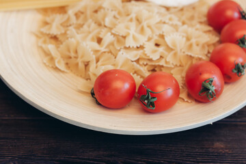 italian pasta pasta cherry tomatoes cooking wooden table