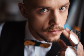 Portrait of young groom with beard and hairstyle