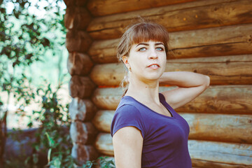 Obraz premium beautiful girl in an old dress near a wooden house