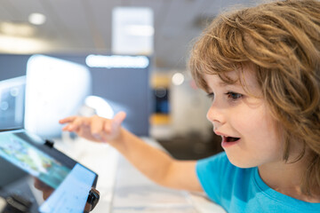 Kid in gadget store. Electronics shopping center. Choose smart technics. Child in computer shop. Digital equipment. Gadget sale.