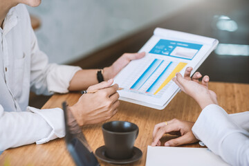 Image of business people brainstorming work using document graphs at the office.