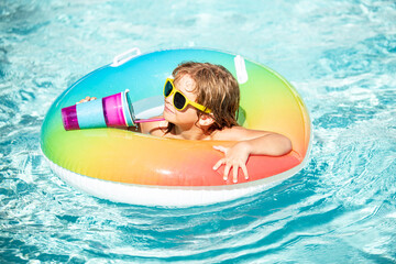 Summer vacation. Child drink cocktail in pool. Kid at aquapark, Summertime vacation.