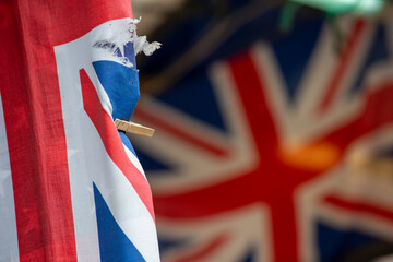A tattered UK flag held together by a clothes peg in Cambridge, England