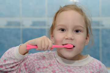 shaggy girl in pajamas brushing his teeth