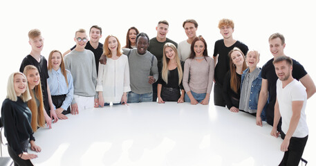 diverse young people standing near a round table