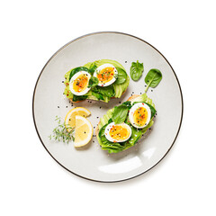 Healthy toast with sliced avocado, boiled eggs, spices and fresh spinach. Delicious breakfast or snack isolated on white background