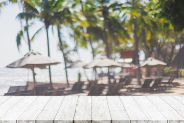 Empty wood table top and blurred summer beach in tropical resort banner background - can used for display or montage your products.