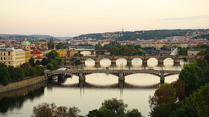 Fototapeta na wymiar Historic bridges in Prague aerial view, famous popular tourist destination, guided tour concept, Charles Bridge sunset cityscape, Prague, Czech Republic