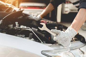 Automobile mechanic repairman hands repairing a car engine automotive workshop with a wrench, car service and maintenance,Repair service.